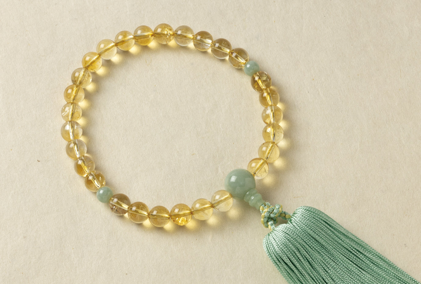 天然トパーズ10ミリ単念珠翡翠仕立